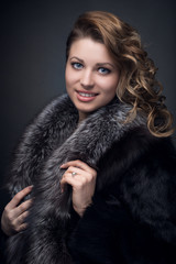 Portrait of young  girl, blonde  in fur coat