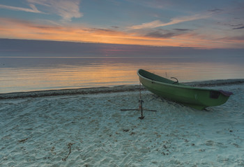 Anchored boat at sandy beach of the Baltic Sea, Latvia