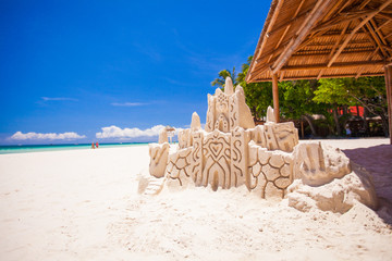 Sand castle on a white tropical sandy beach in