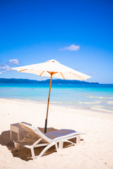 Two chairs and umbrella on stunning tropical beach