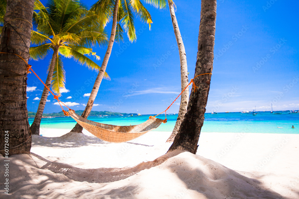 Wall mural view of cozy straw hammock on the tropical white beach