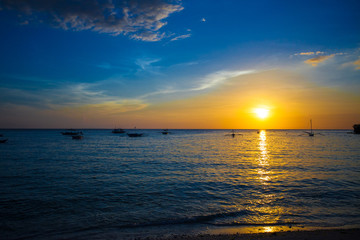 Small sailboat on the beautiful sunset in the Philippines