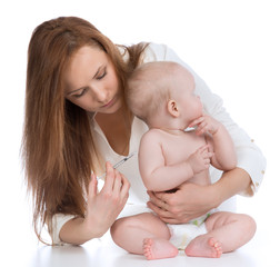 Doctors with syringe vaccinating child baby flu injection shot