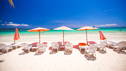 Beach chairs in exotic resort on perfect white sandy beach