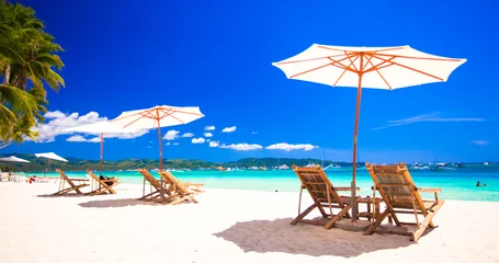 Beach chairs on exotic tropical white sandy beach