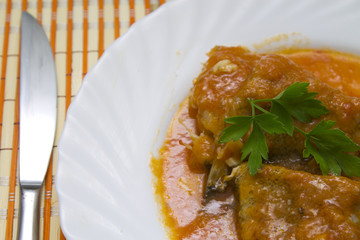 pieces of cod with tomato on plate