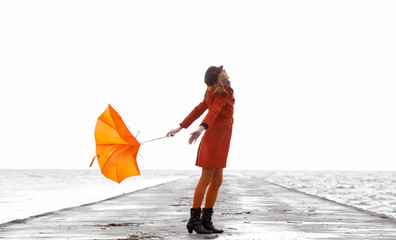 Broken Orange umbrella fly from the girl.