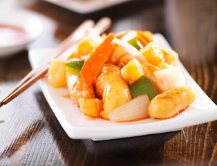 chinese sweet and sour chicken with chopsticks