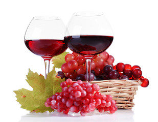 Wineglasses with red wine and  grape in wicker basket isolated
