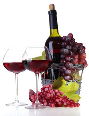 Wineglasses with red wine, grape and bottle isolated on white