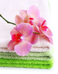 Orchid flower and towels, isolated on white