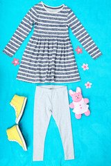 Obraz premium Beautiful clothes for little girl on blue background