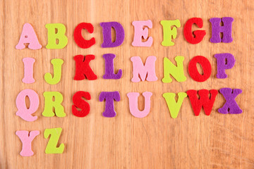 English alphabet on wooden background