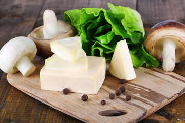 Cream cheese with vegetables and greens on wooden board © Africa Studio