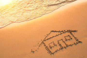 House painted on beach sand.