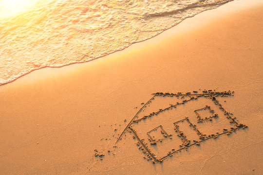 House painted on beach sand.