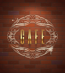 Cafe ornate golden sign on vintage brick wall.