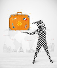 man in full body suit presenting vacation suitcase