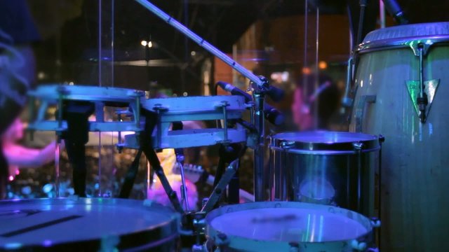 Percussionist playing drums and girls dancing.