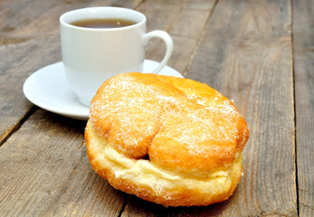 coffee and donut on wooden table