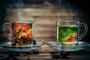 Teapot and glass cups with  tea against wooden background