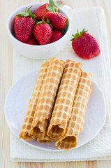 Homemade waffle with strawberry on a wooden surface