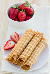 Homemade waffle with strawberry on a wooden surface