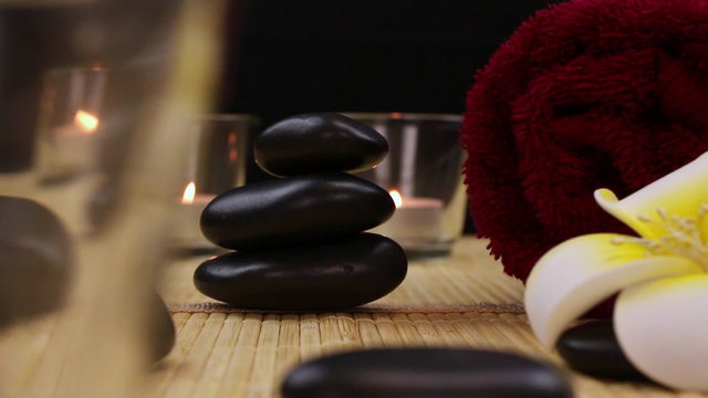 spa therapy stones surrounded by candles
