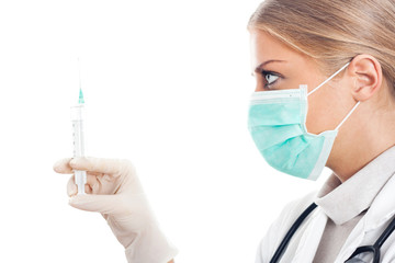 Doctor with protective mask and syringe