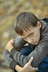 sad little boy outdoors in autumn