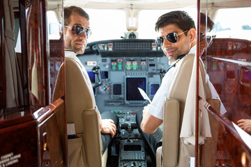 Confident Pilots In Cockpit Of Plane