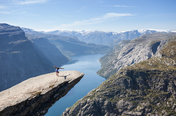 female gymnast doing a handstand on trolltunga rock in norway