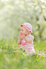 Girl Licking Bottle in Garden