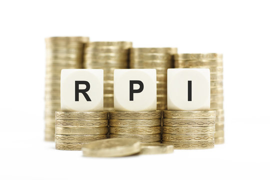 RPI (Retail Price Index) on Coin Stacks Isolated White Backgroun
