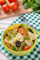 Delicious pasta with tomatoes on plate on table close-up