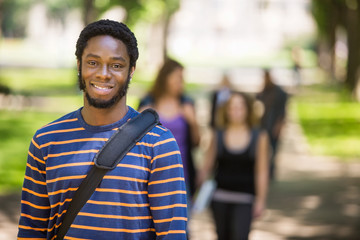 Young Male Grad Student Smiling On Campus