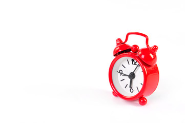 Classic red alarm clock over white background