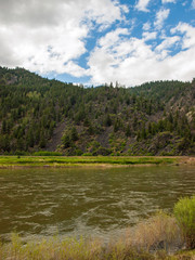 Fototapeta premium Wide Mountain River Cuts a Valley - Clark Fork River Montana USA