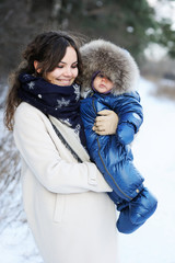 Fototapeta premium Happy family enjoying a walk in winter park