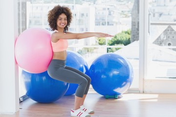 Fototapeta premium Sporty woman with exercise ball in fitness studio