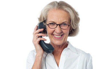 Senior lady attending phone call