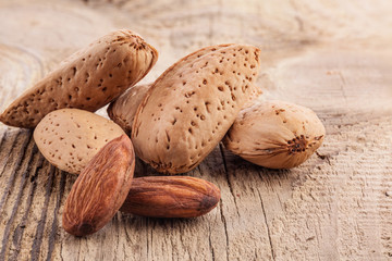 Almond nuts on very old wooden table, closeup
