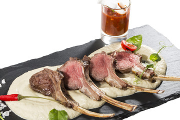 lamb ribs cooked on the grill served on a hot stone