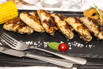 chicken wings and sweet corn cooked on the grill