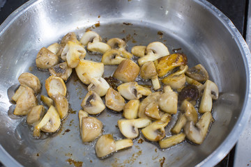 cooking mushrooms in a pan in a restaurant