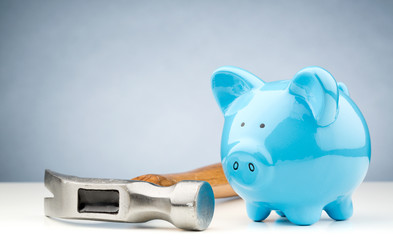 Hammer Lying Next to a Piggy Bank