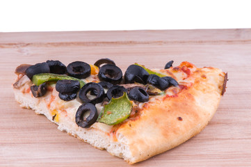 pizza slice on chopping board close up