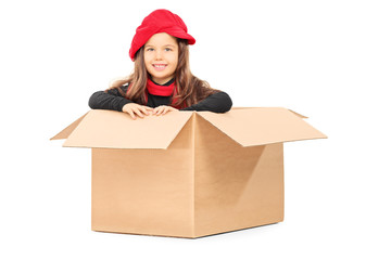 Playful little girl in carton box