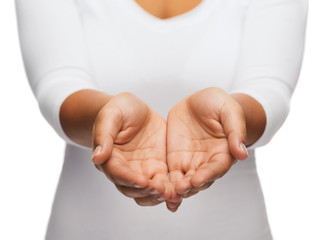 womans cupped hands showing something