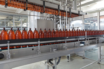 The interior of brewery, conveyor line for the bottling of beer